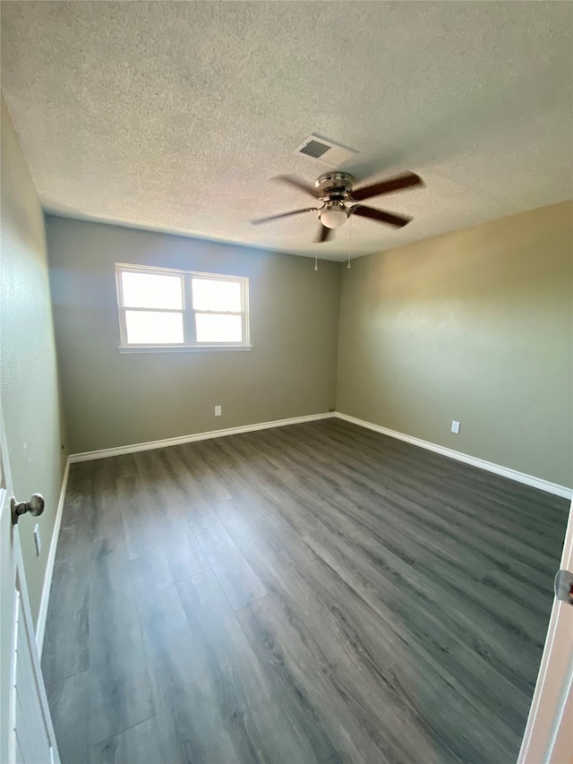 empty room featuring a textured ceiling, ceiling fan, and dark hardwood / wood-style flooring