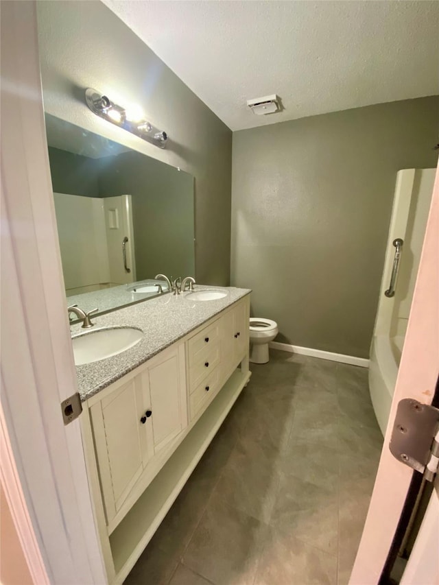 8922 Glacier Ave, Texas City, TX 77591 - bathroom featuring toilet, a sink, double vanity, and baseboards