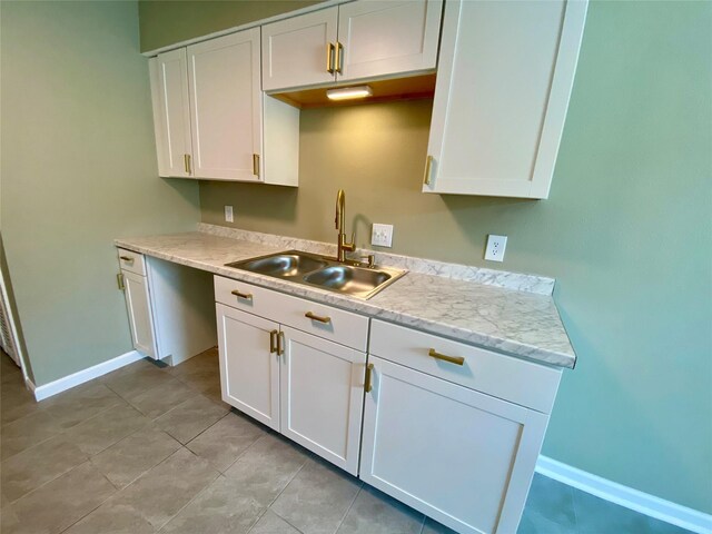 8922 Glacier Ave, Texas City, TX 77591 - kitchen featuring baseboards, white cabinets, a sink, and light countertops