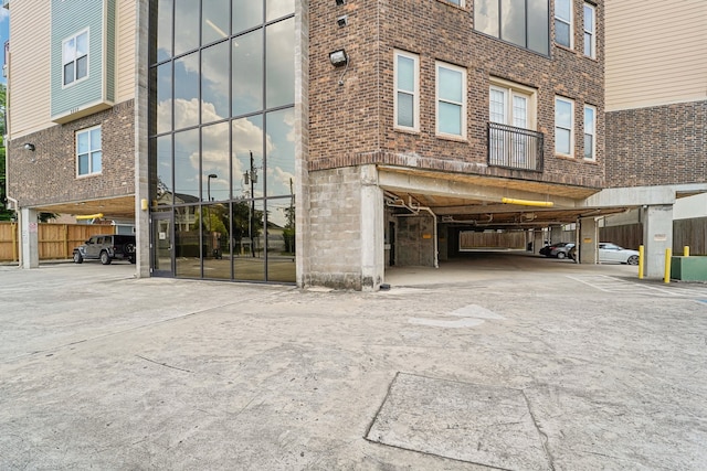 property entrance with brick siding and fence