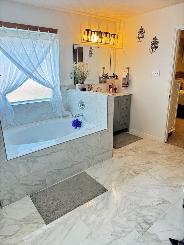 bathroom featuring tiled bath and vanity