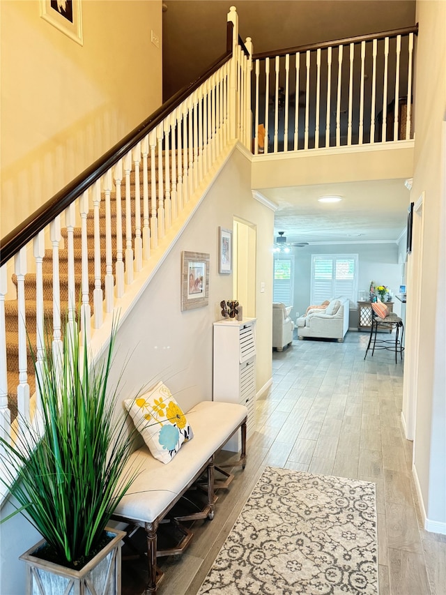 interior space featuring a towering ceiling and hardwood / wood-style flooring