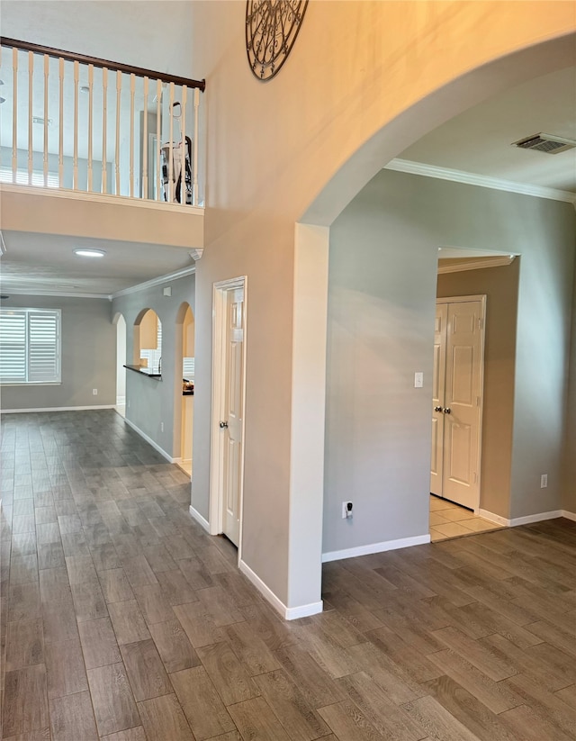 interior space featuring ornamental molding and hardwood / wood-style flooring