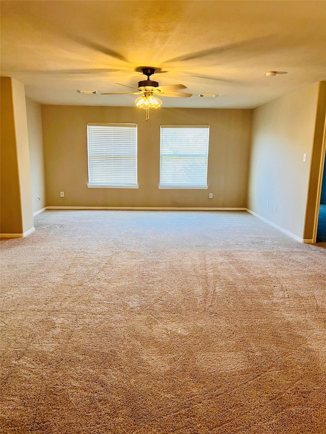 carpeted spare room with ceiling fan