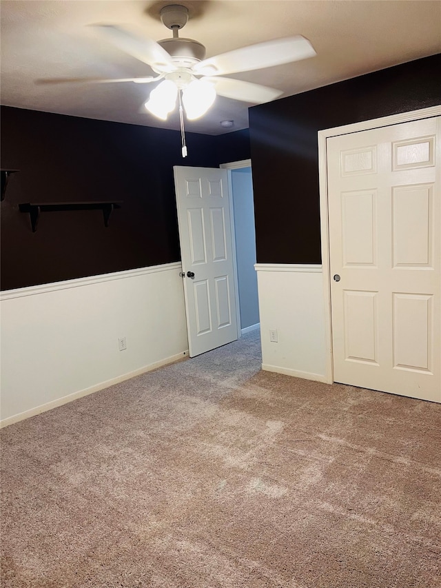 unfurnished bedroom featuring a closet, carpet, and ceiling fan