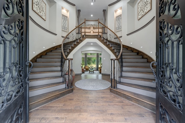 foyer with a towering ceiling and hardwood / wood-style floors