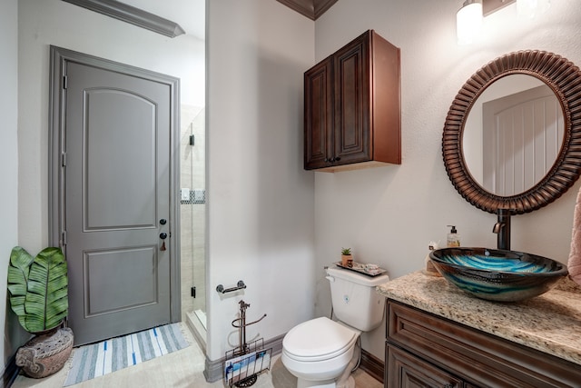 bathroom featuring vanity, crown molding, toilet, and a shower with door