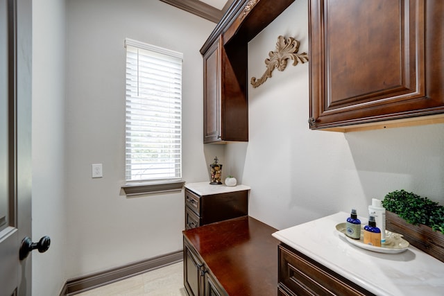 bathroom featuring crown molding and vanity