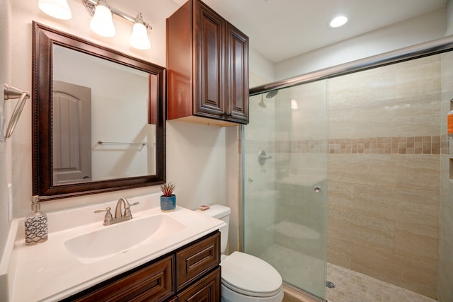 bathroom with vanity, toilet, and an enclosed shower