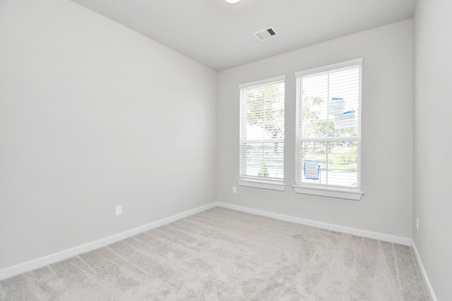 unfurnished room with light carpet