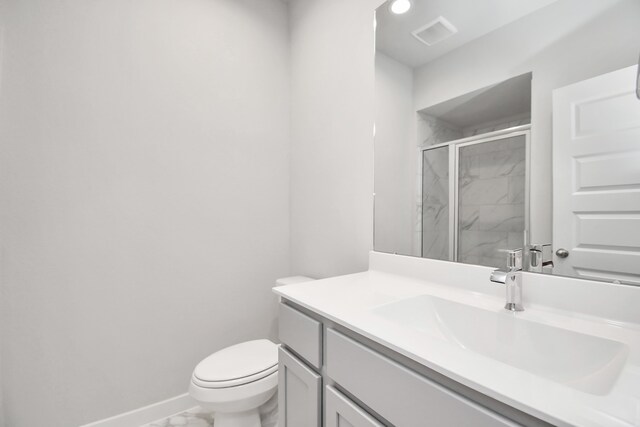 bathroom with vanity, toilet, and an enclosed shower