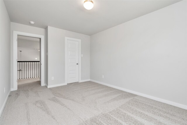 unfurnished bedroom featuring light carpet and a closet