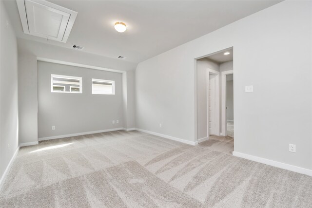 spare room featuring light colored carpet