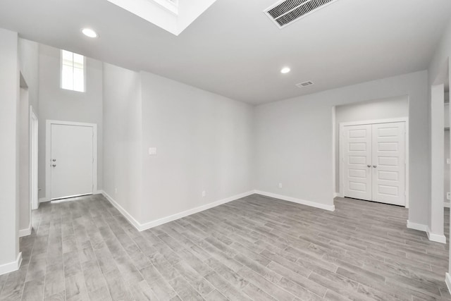 spare room featuring recessed lighting, visible vents, baseboards, and light wood finished floors