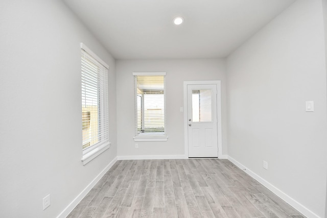 entrance foyer with light wood-style flooring and baseboards