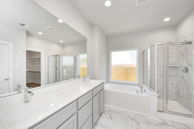 full bath with visible vents, a marble finish shower, and a sink