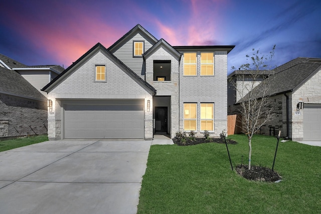 traditional home with brick siding, concrete driveway, a garage, and a front yard