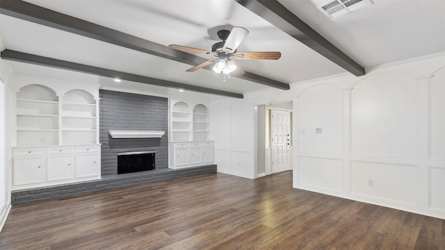 unfurnished living room with a fireplace, beam ceiling, ceiling fan, built in shelves, and dark hardwood / wood-style floors