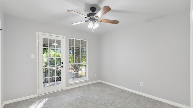 spare room featuring ceiling fan, carpet floors, and french doors