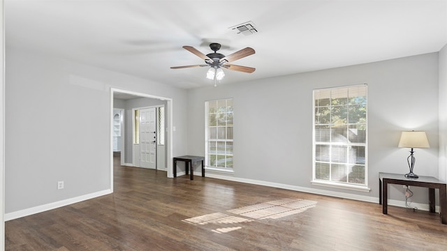 spare room featuring dark hardwood / wood-style floors and ceiling fan