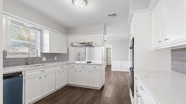 kitchen with dark wood-type flooring, tasteful backsplash, white cabinets, black appliances, and sink