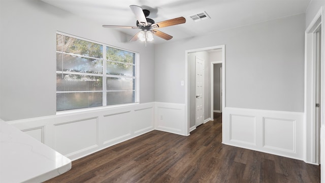 spare room with ceiling fan and dark wood-type flooring