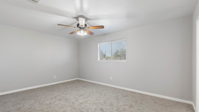 carpeted empty room featuring ceiling fan