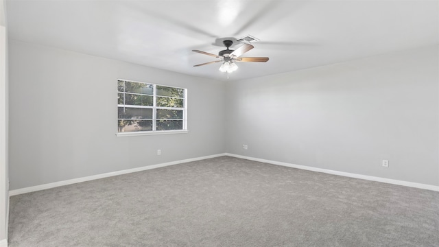 unfurnished room with ceiling fan and carpet