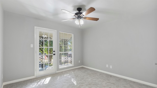 empty room with ceiling fan and light carpet