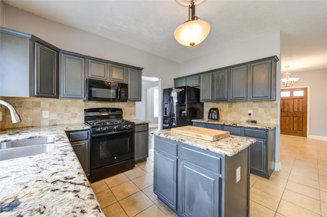 kitchen featuring decorative backsplash, a kitchen island, hanging light fixtures, sink, and black appliances