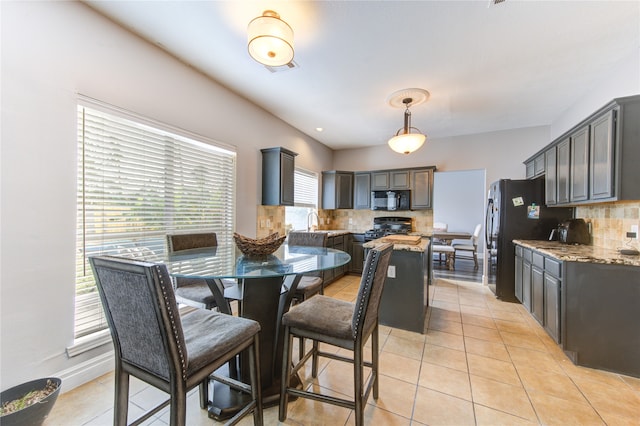 dining room featuring sink and light tile patterned floors