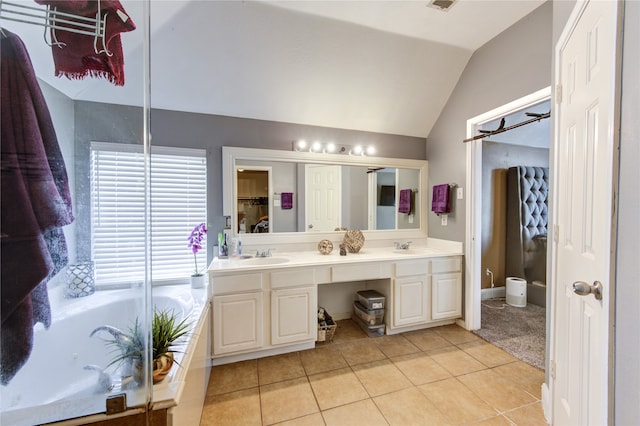 bathroom featuring vanity, tile patterned flooring, and vaulted ceiling