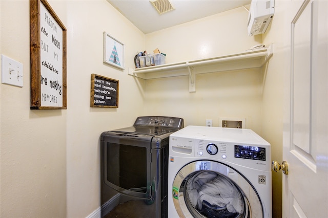 clothes washing area with washer and dryer