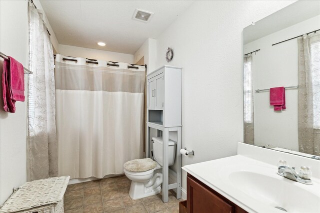 bathroom featuring vanity, toilet, and a shower with curtain