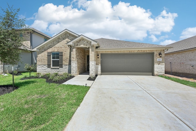 view of front of house with a garage and a front lawn