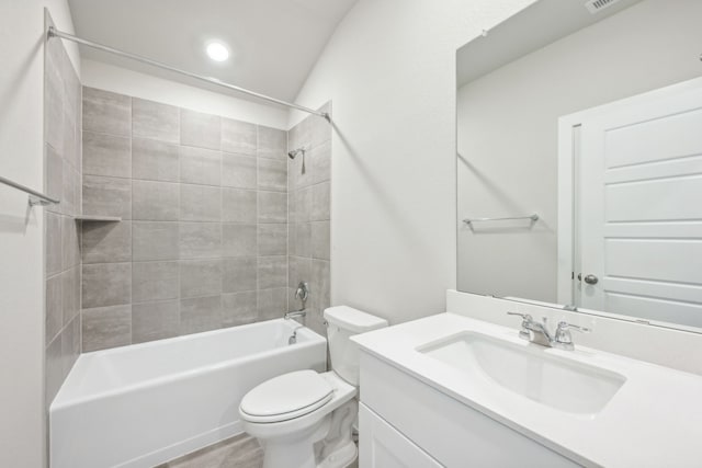 full bathroom featuring toilet, vanity, and tiled shower / bath