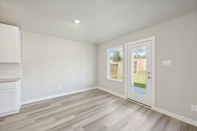 unfurnished dining area featuring light hardwood / wood-style floors