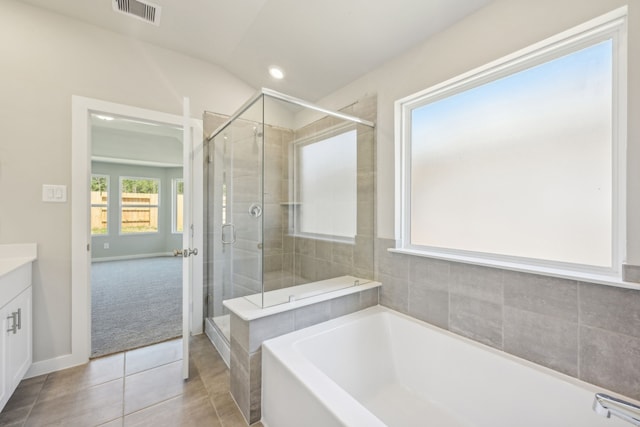 bathroom featuring tile patterned flooring, vanity, separate shower and tub, and lofted ceiling