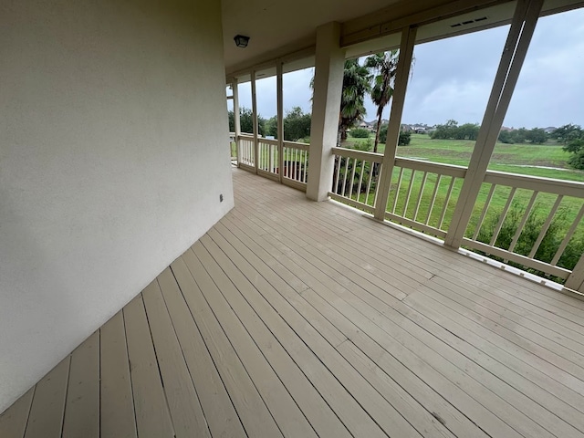 wooden deck with a lawn