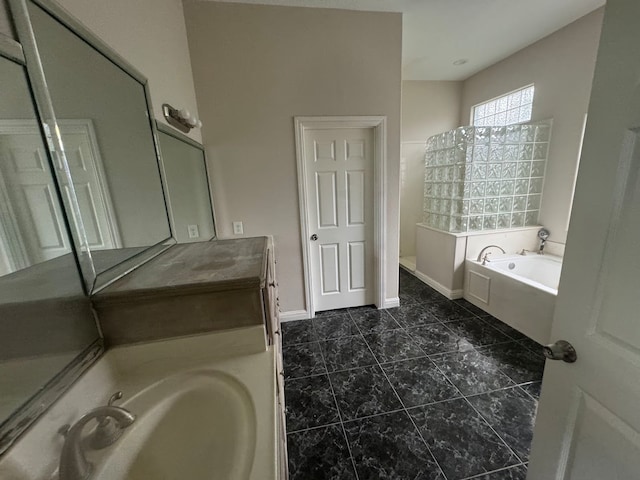 bathroom featuring a bath and vanity