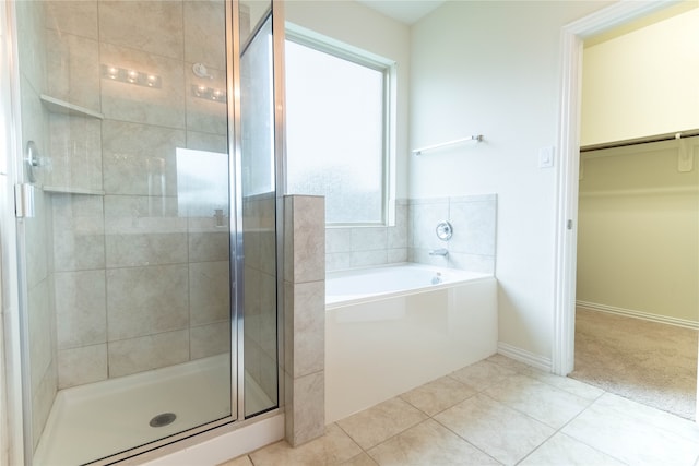 bathroom featuring shower with separate bathtub and tile patterned flooring