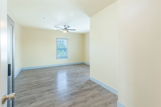 empty room featuring light hardwood / wood-style floors and ceiling fan