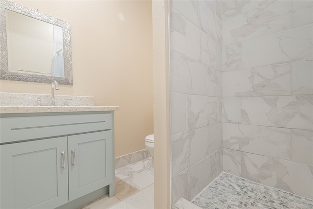 bathroom with walk in shower, vanity, and toilet