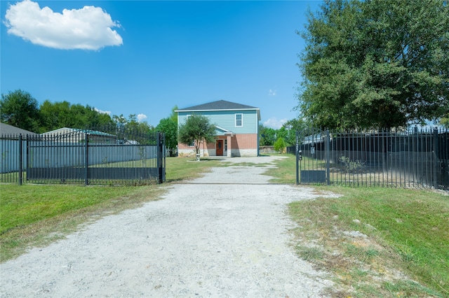 view of gate featuring a lawn