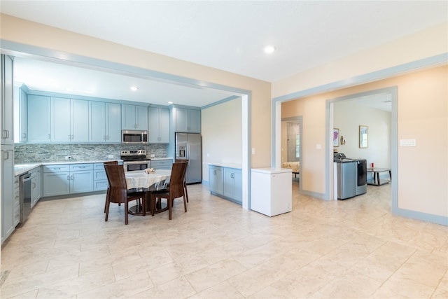 kitchen featuring decorative backsplash, a center island, and stainless steel appliances