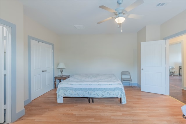 bedroom featuring a closet, light hardwood / wood-style floors, and ceiling fan