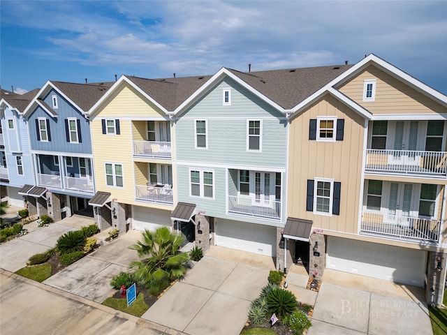 view of property featuring a garage and a balcony