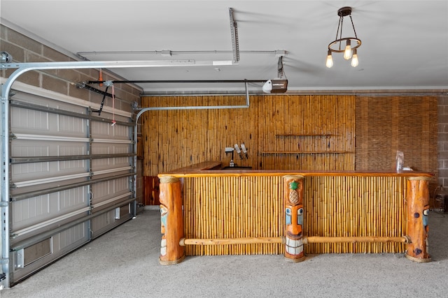 garage with a garage door opener and wooden walls