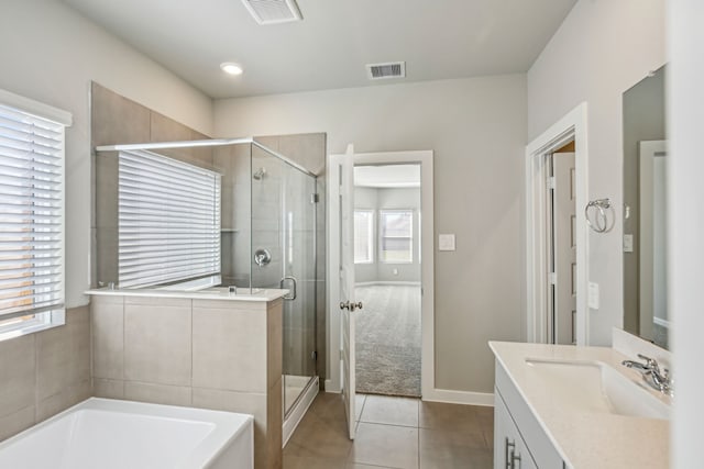 bathroom with vanity, tile patterned floors, and separate shower and tub