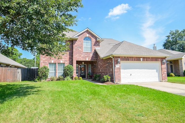 view of property with a garage and a front lawn